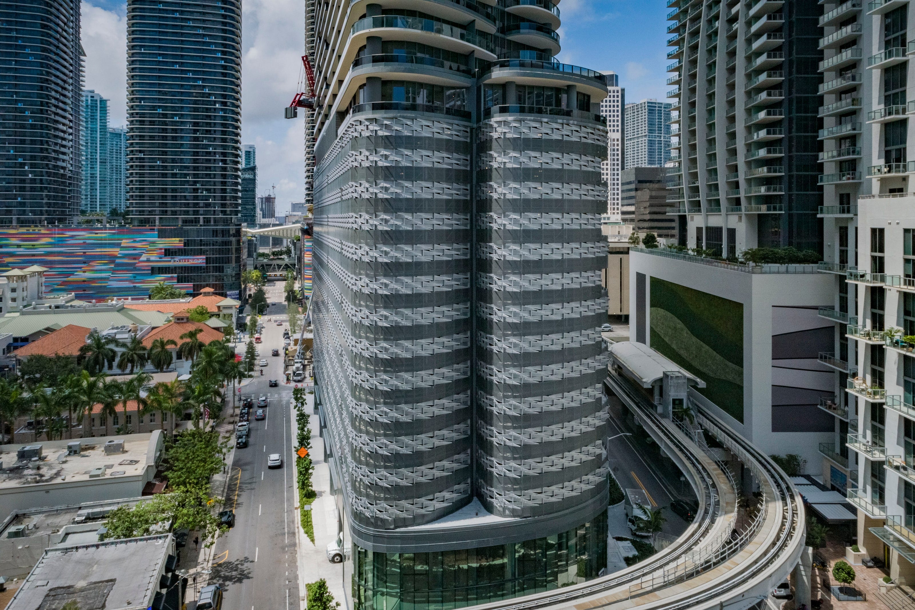 Brickell Flatiron's perforated metal façade above the Metromover tracks