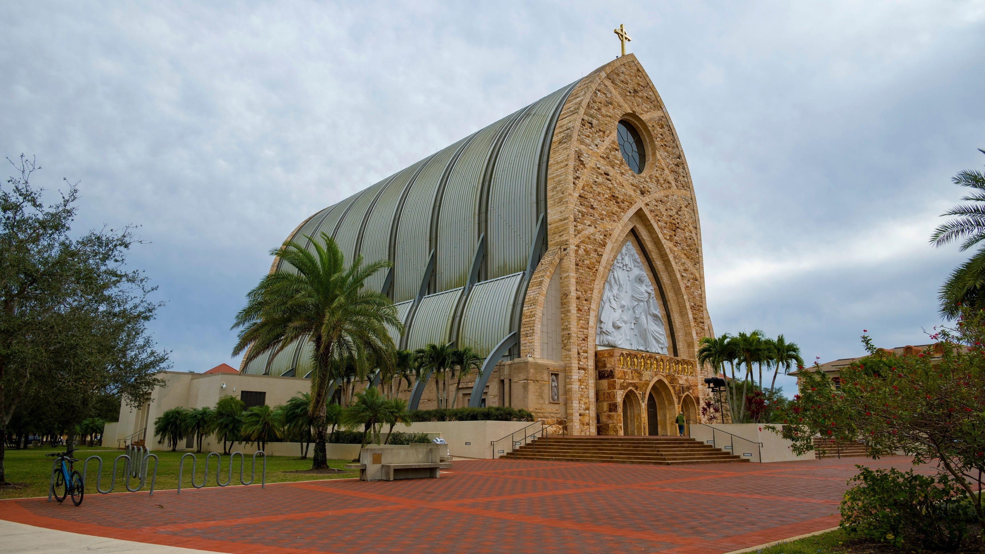 Ave Maria Church's arched stone front and curved standing seam metal roof