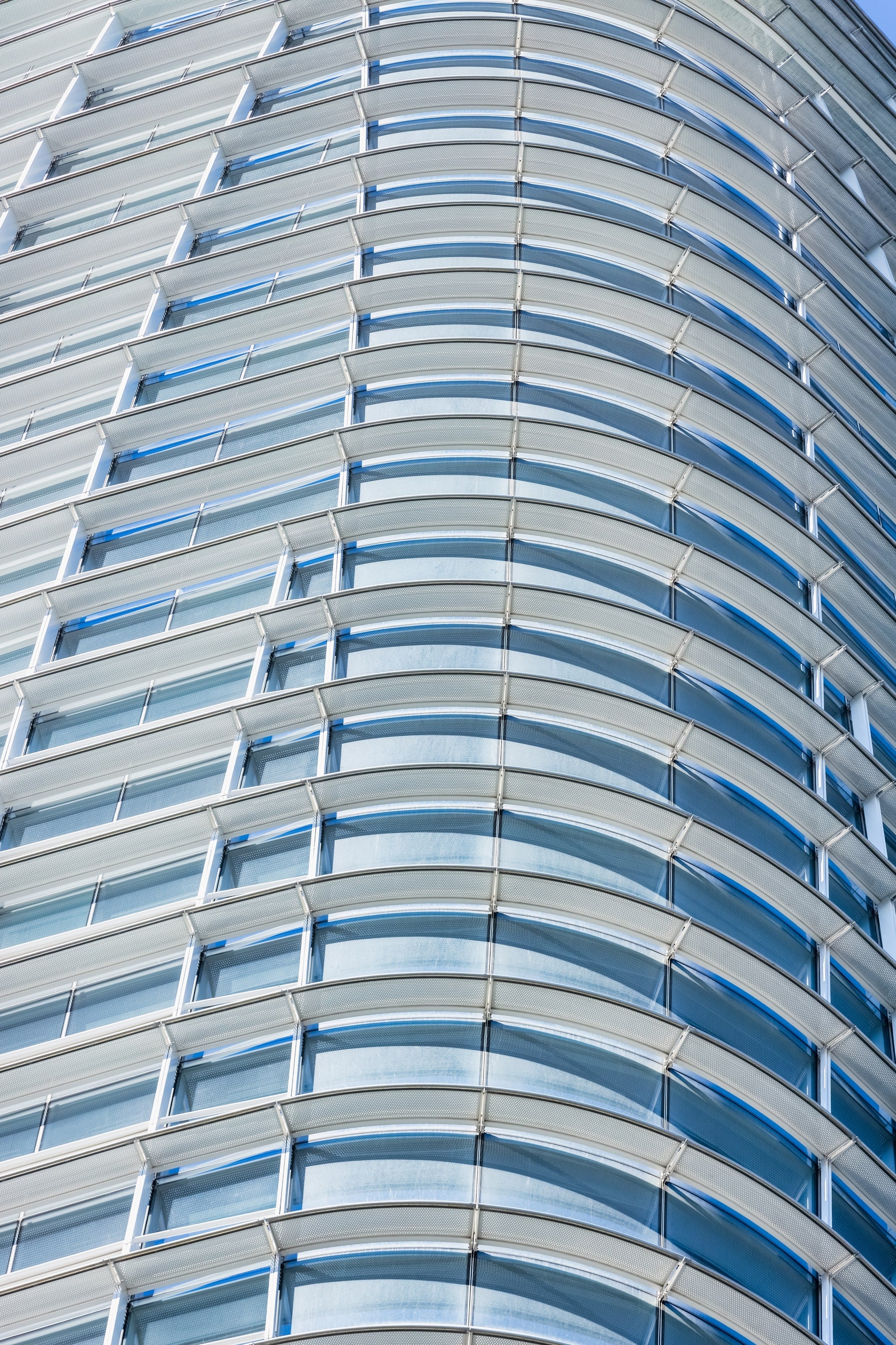Close view of Salesforce Tower's curved white sunshades and glass