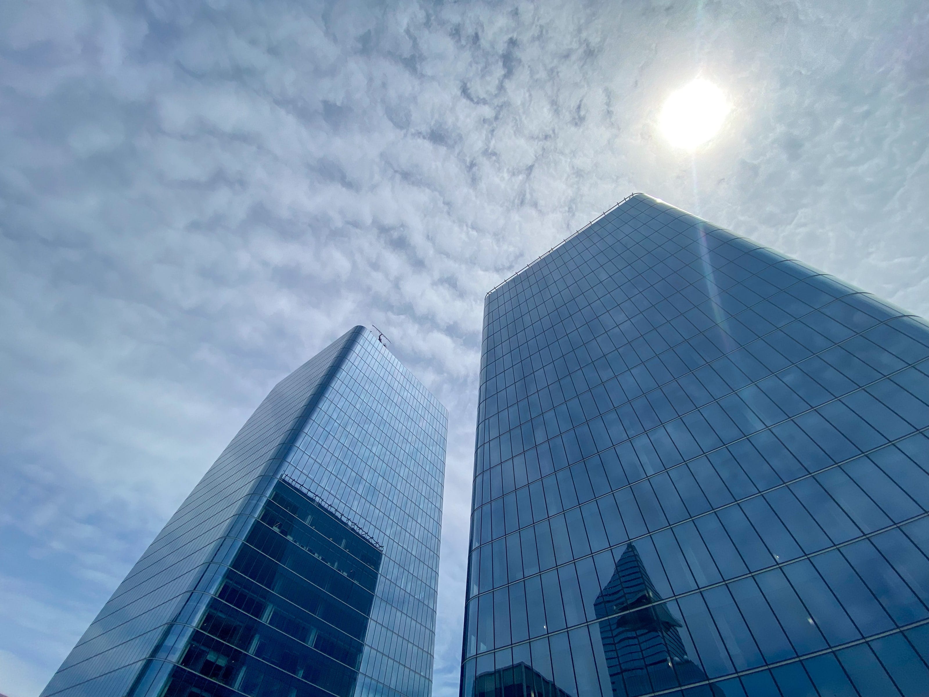 The two Manhattan West towers from below, against a bright sky