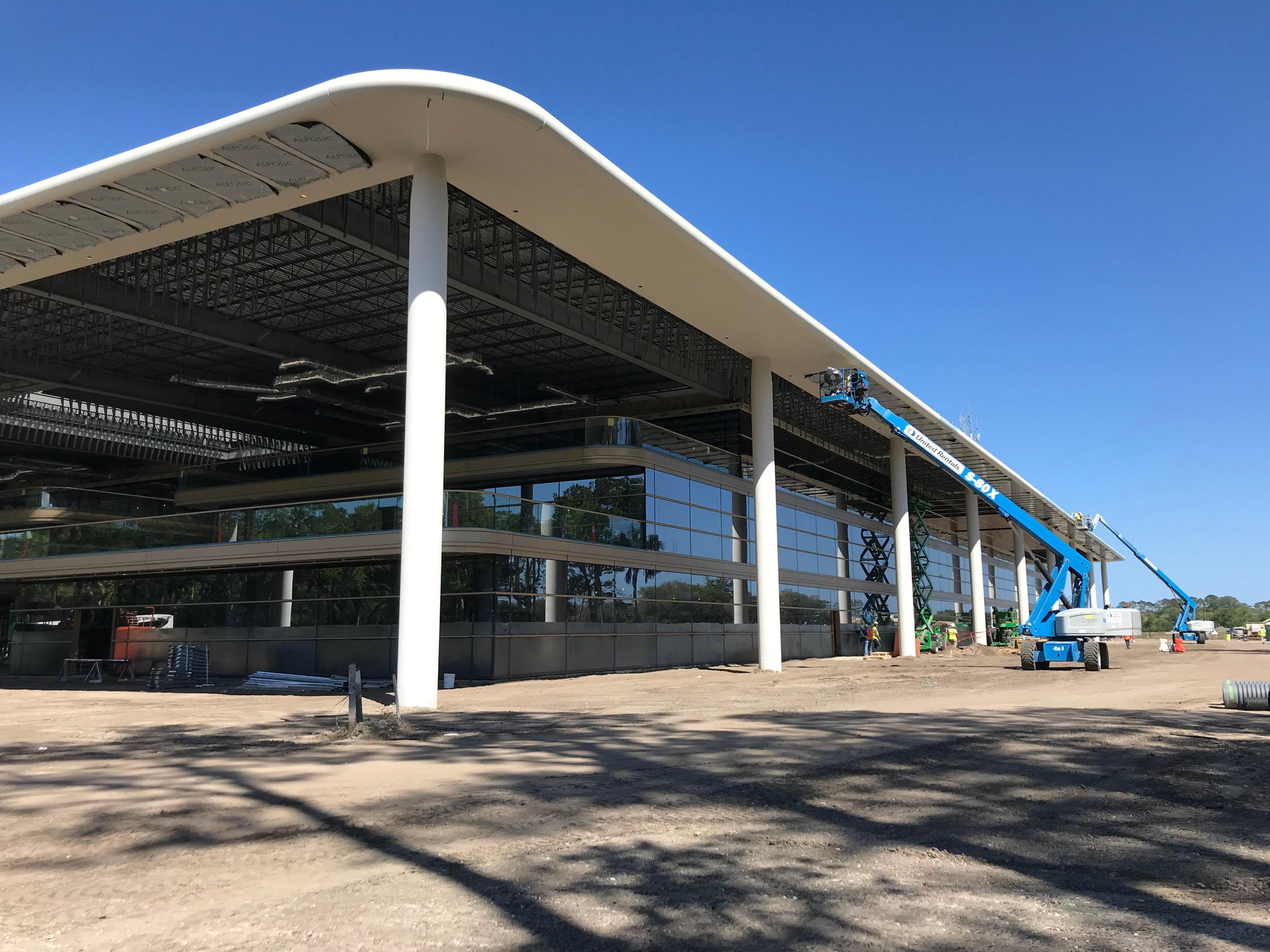 PGA Tour Headquarters canopy during construction, with a lift at the edge