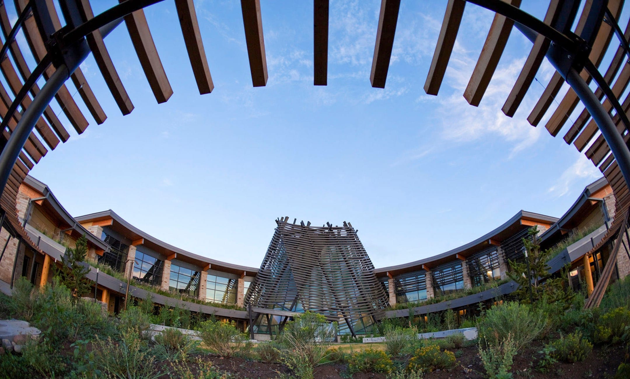 Southern Ute Cultural Center seen through a ring of timber beams