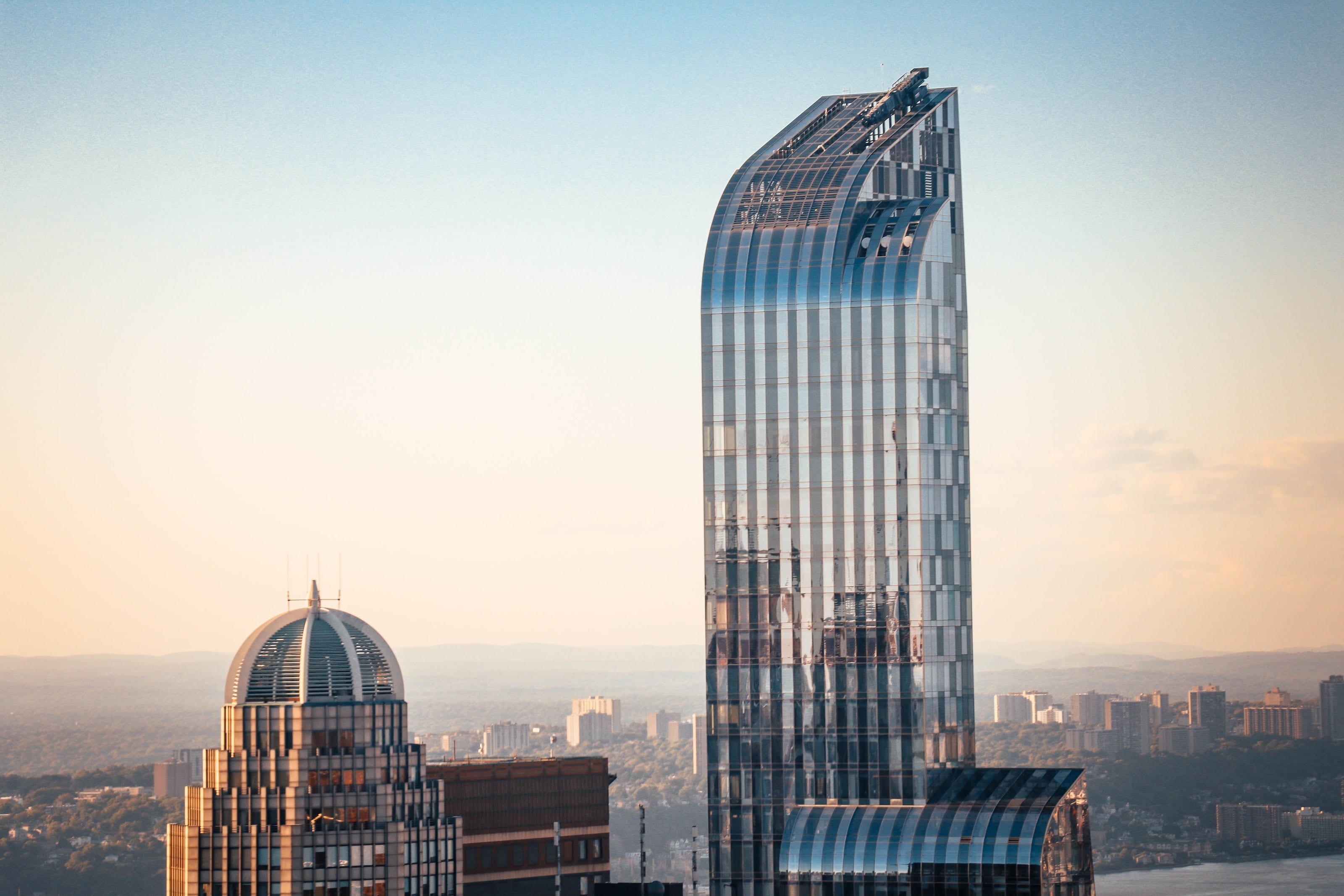 One57 tower's curved glass and metal crown above the Manhattan skyline