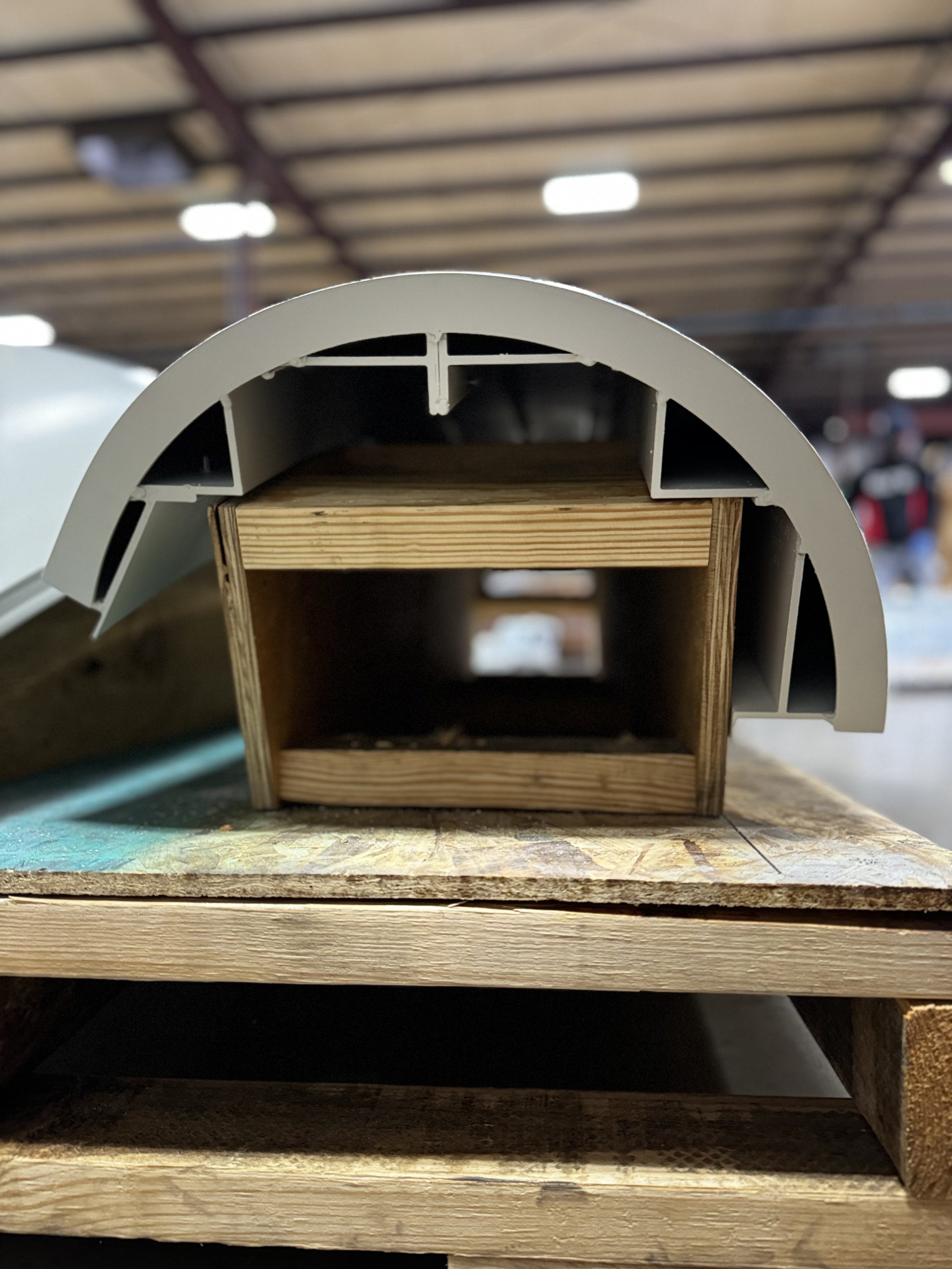 End view of a curved canopy edge section showing the formed aluminum profile