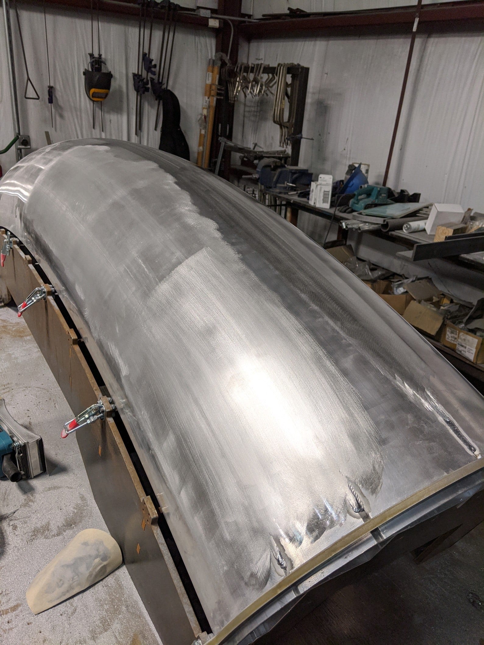 Hand-contoured aluminum canopy component before painting