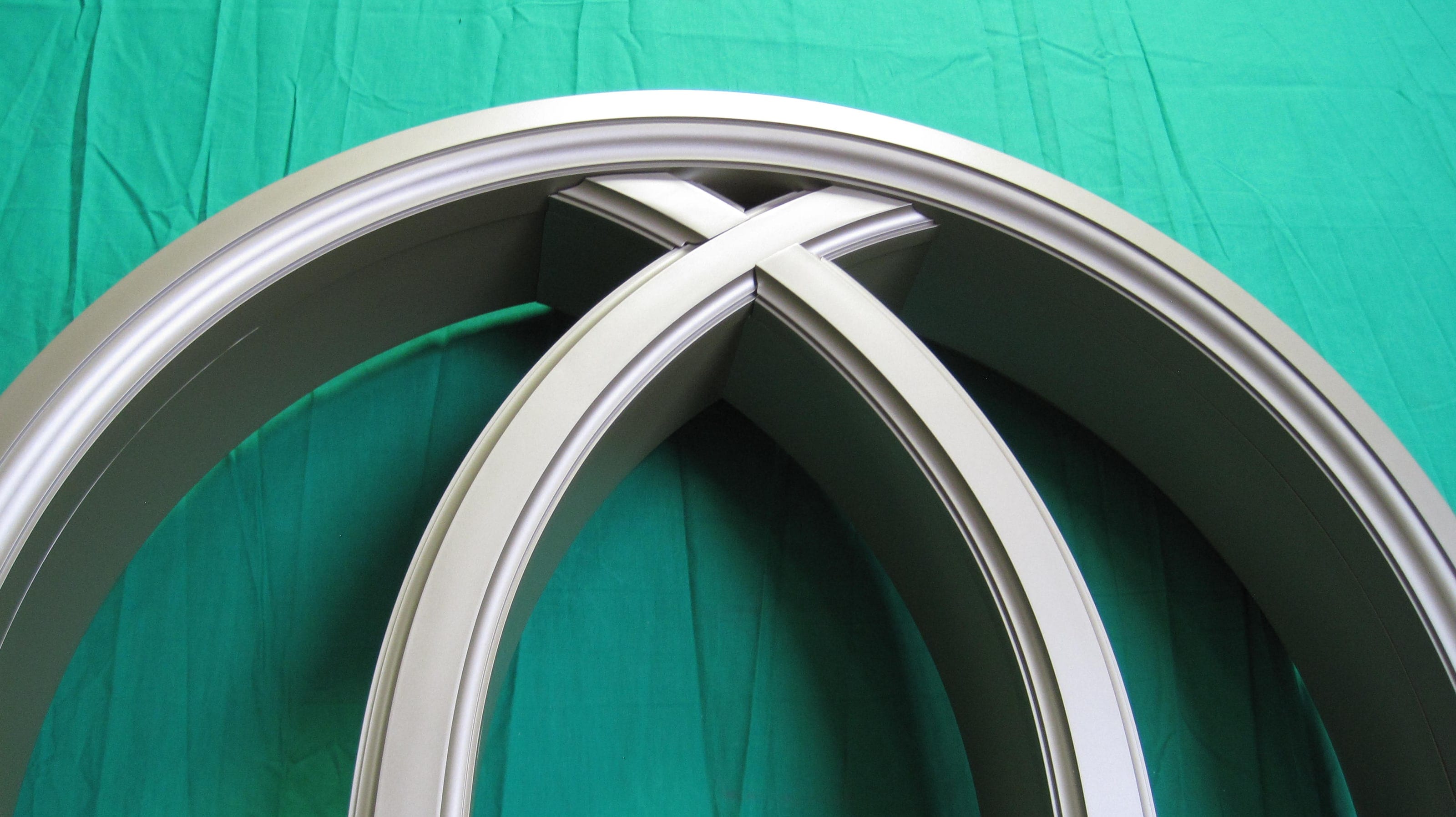 Painted aluminum window frame with intersecting arched muntins