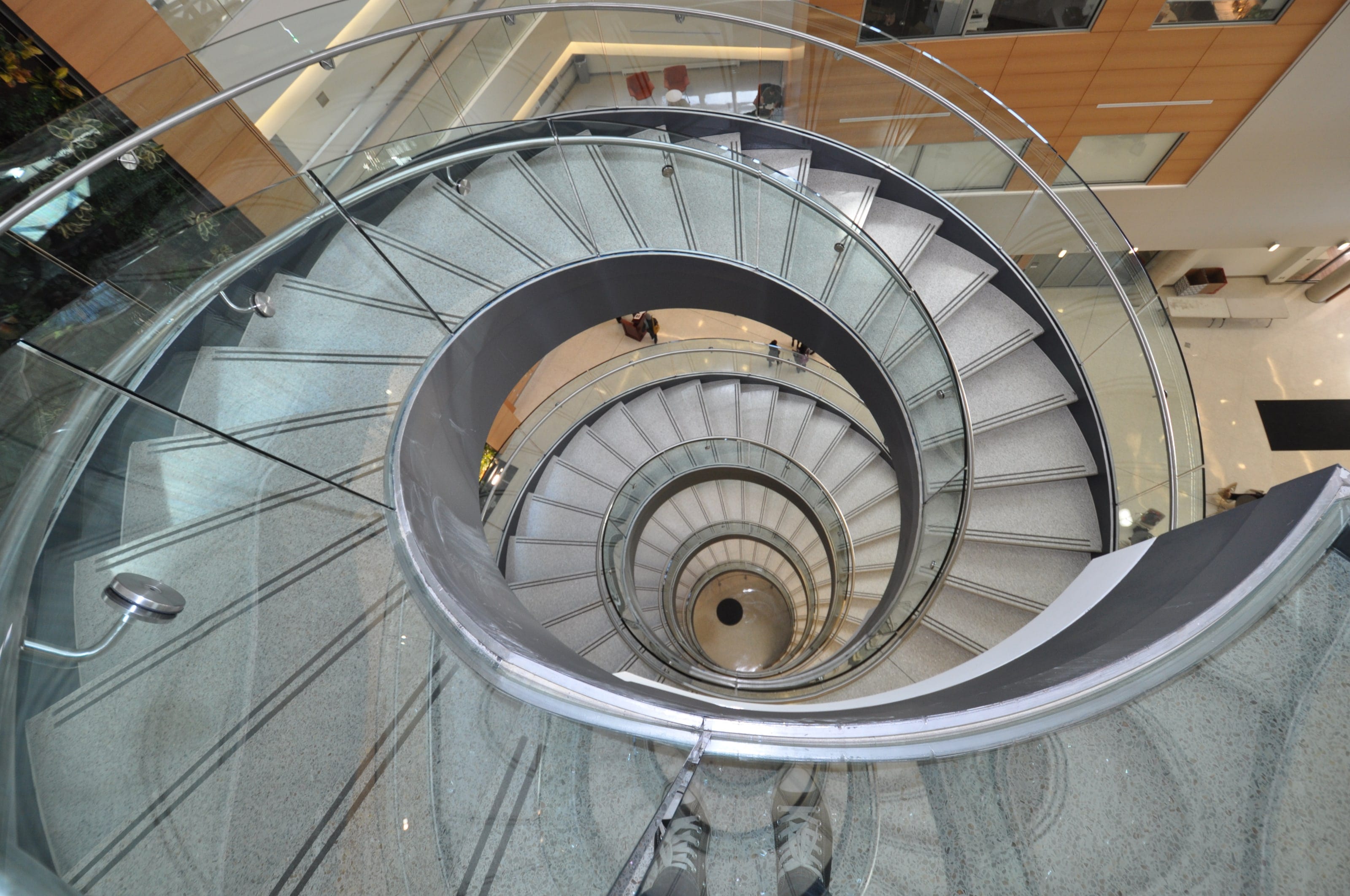Looking straight down a self-supporting helical staircase at Drexel University, its curved rail spiraling to the floor