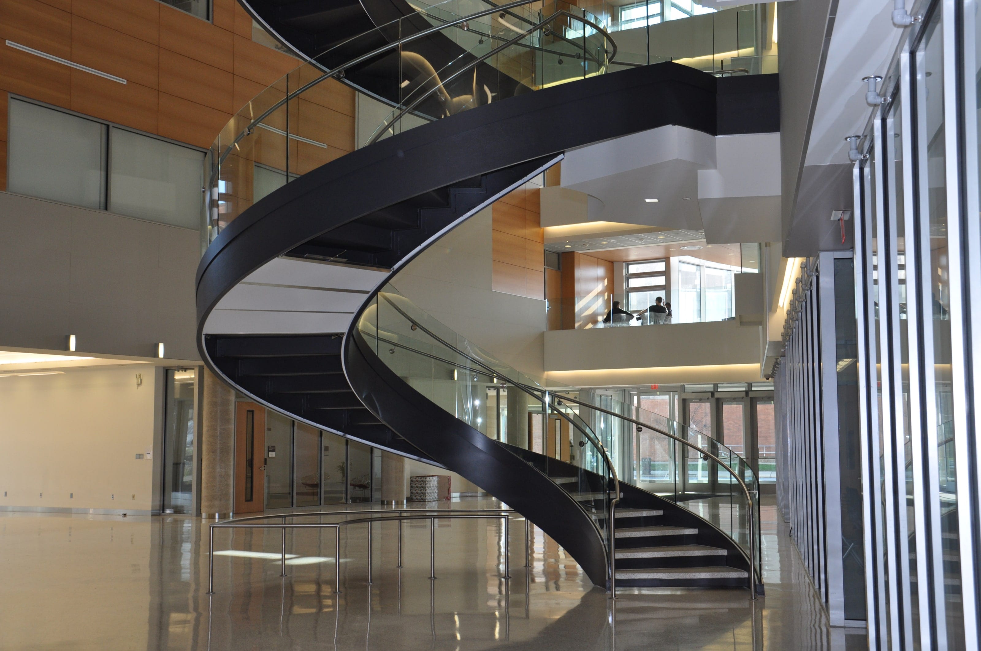 The underside of a helical stair curving over Drexel University's lobby