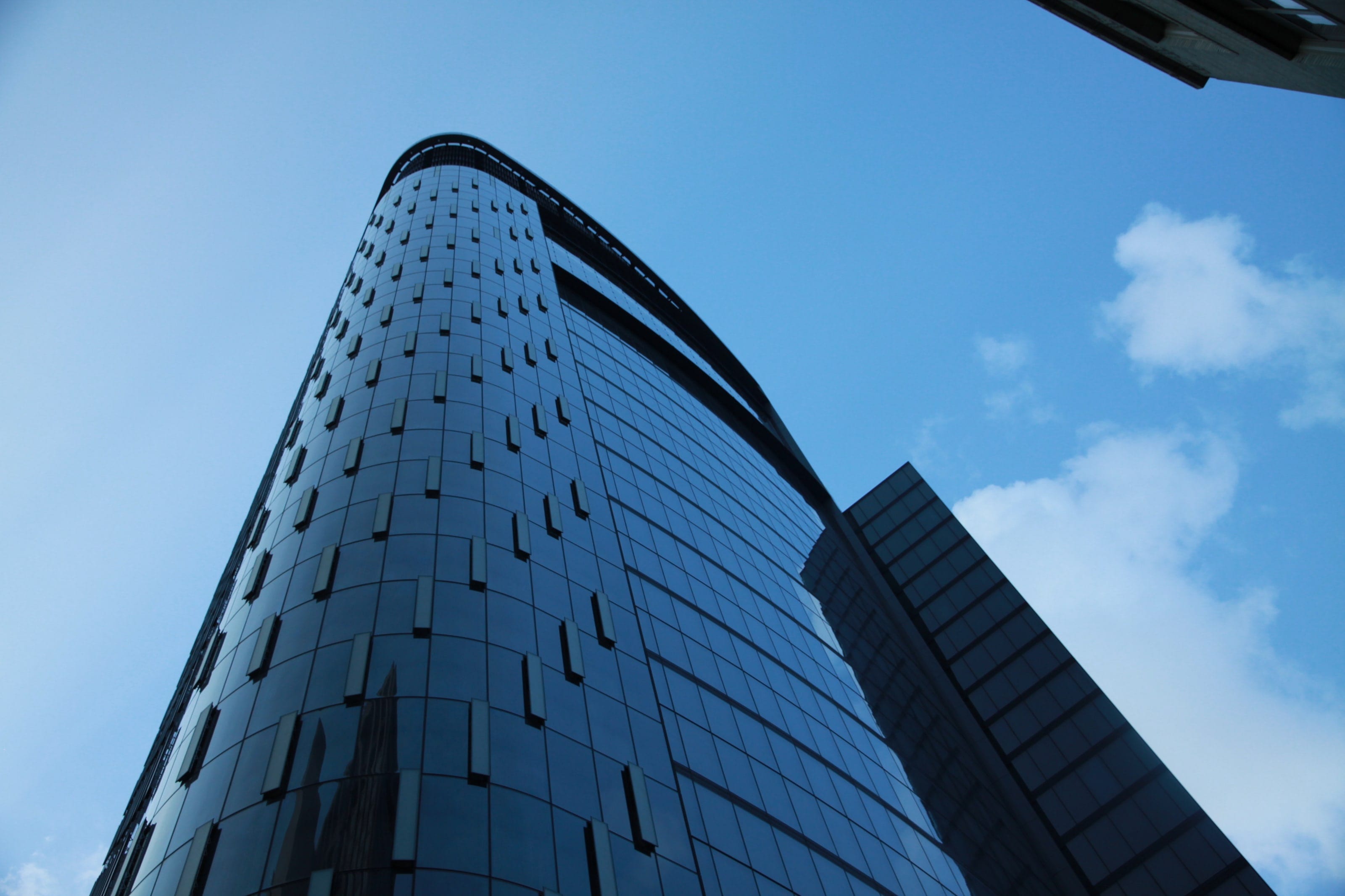 Tower at PNC Plaza's rounded glass corner rising into the sky