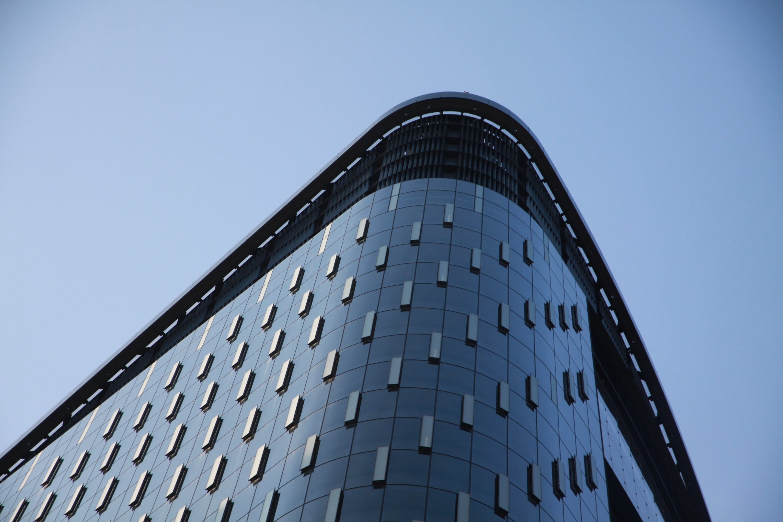 Tower at PNC Plaza's curved corner and crown against a pale sky