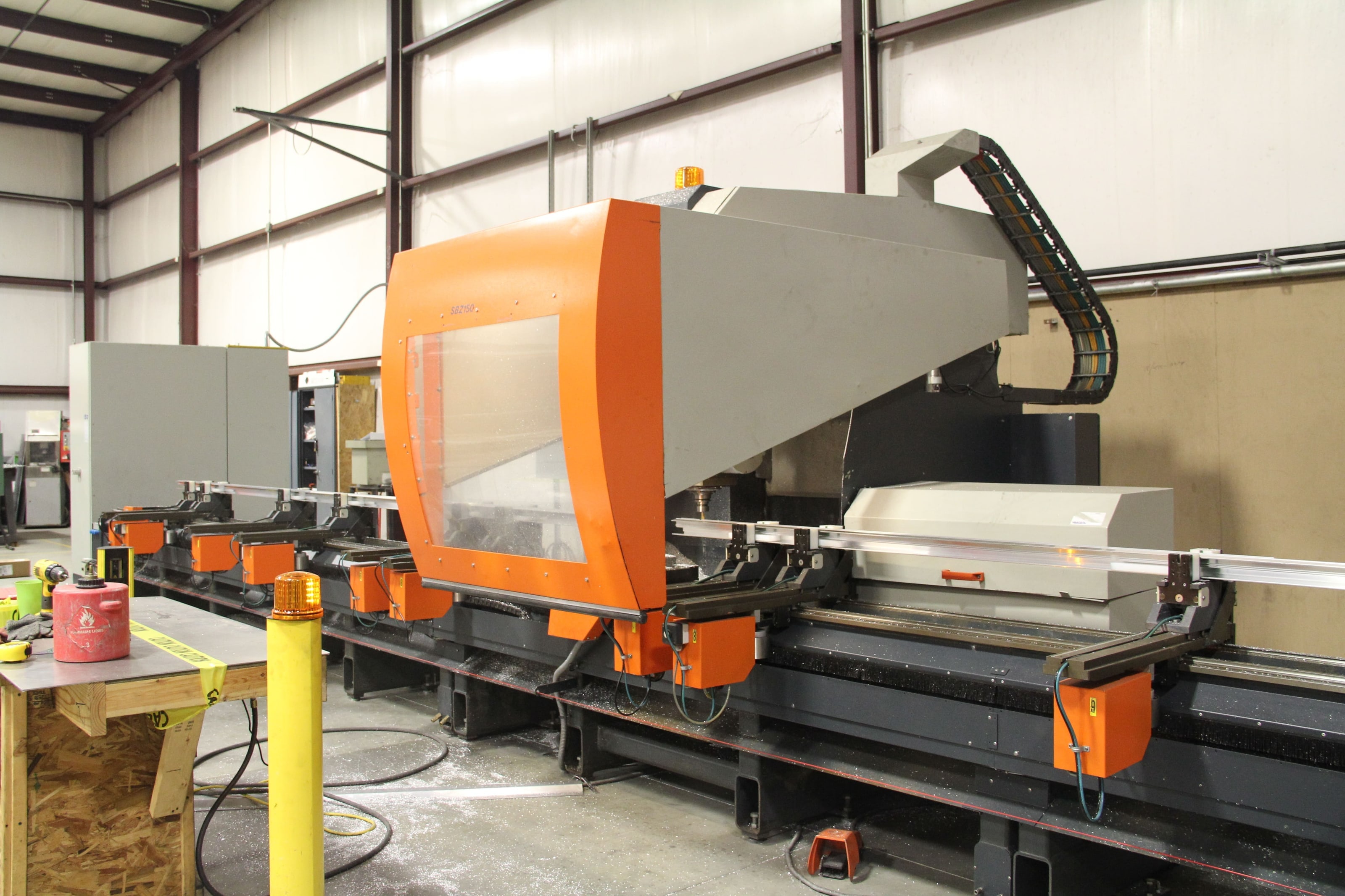 Orange CNC machining center for long aluminum extrusions in the Mid-Am shop