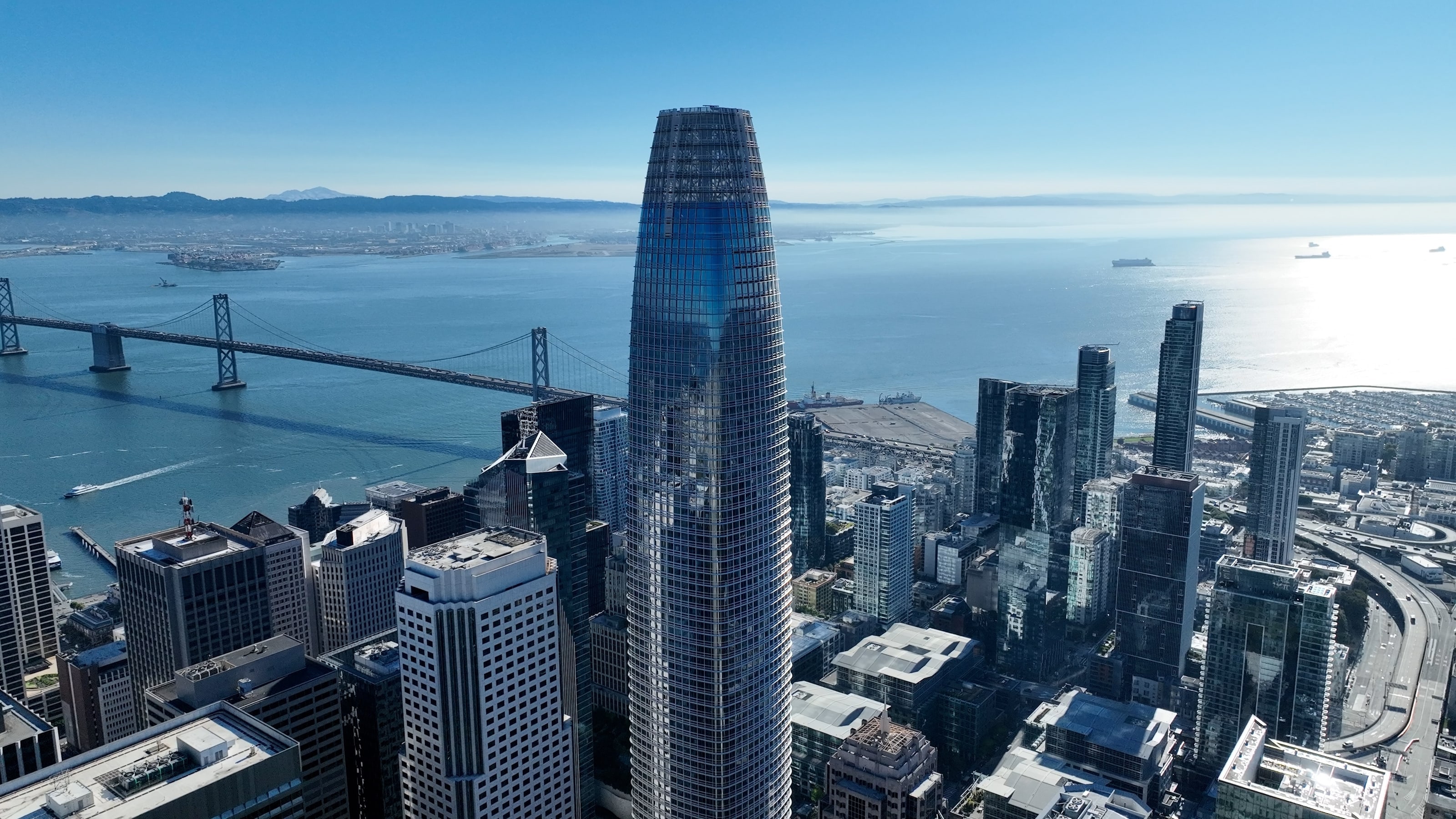 Aerial view of Salesforce Tower with the Bay Bridge behind